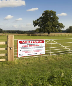 a farm biosecurity sign installed on a gate.